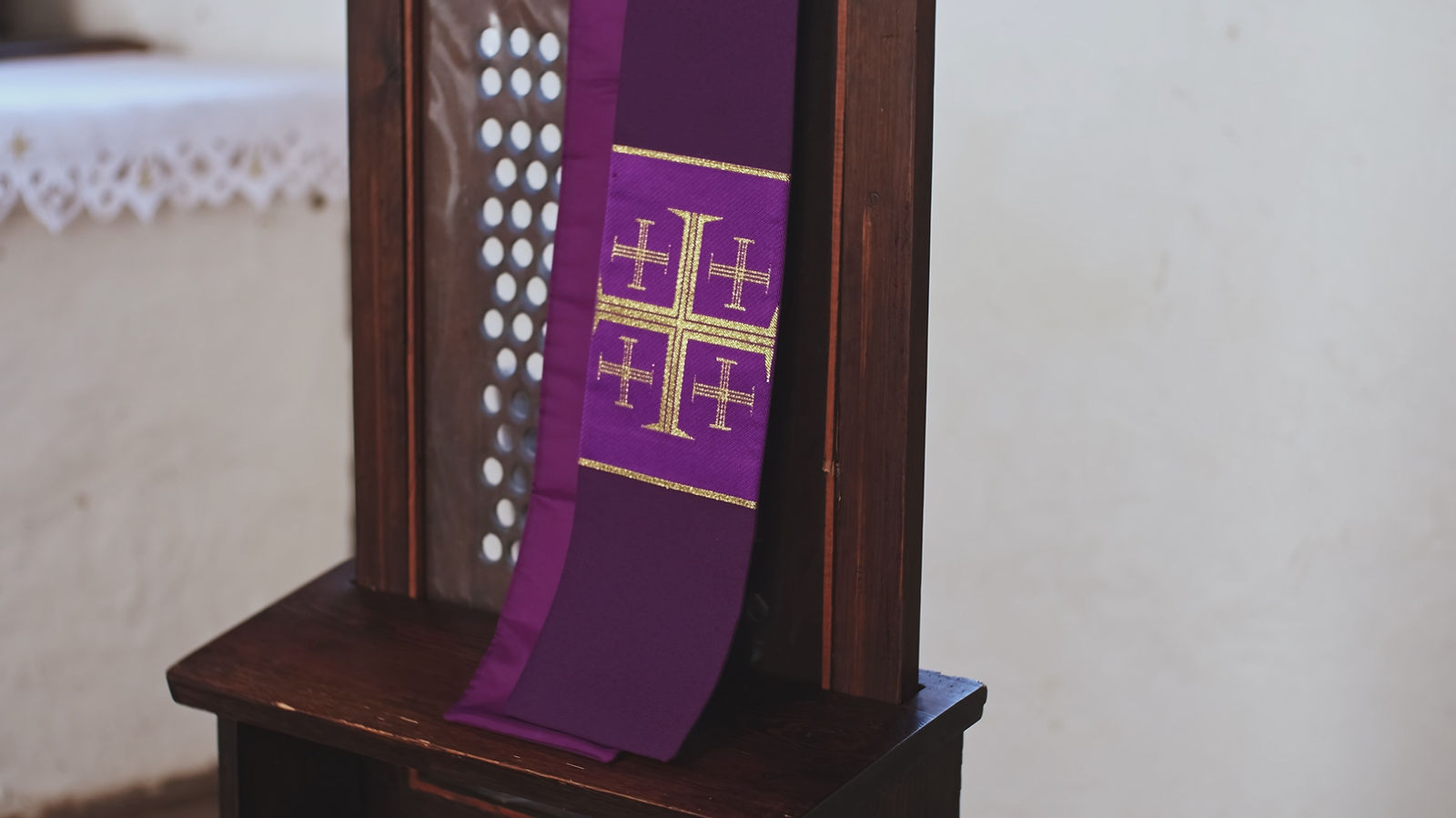Purple Catholic Priest Stole with Embroidered Jerusalem Cross Hanging Over Grate of Simple